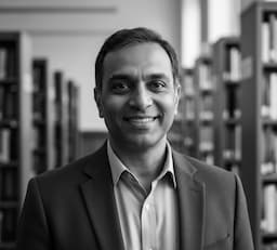 Imran, Librarian & Content Curator, holding a stack of books.